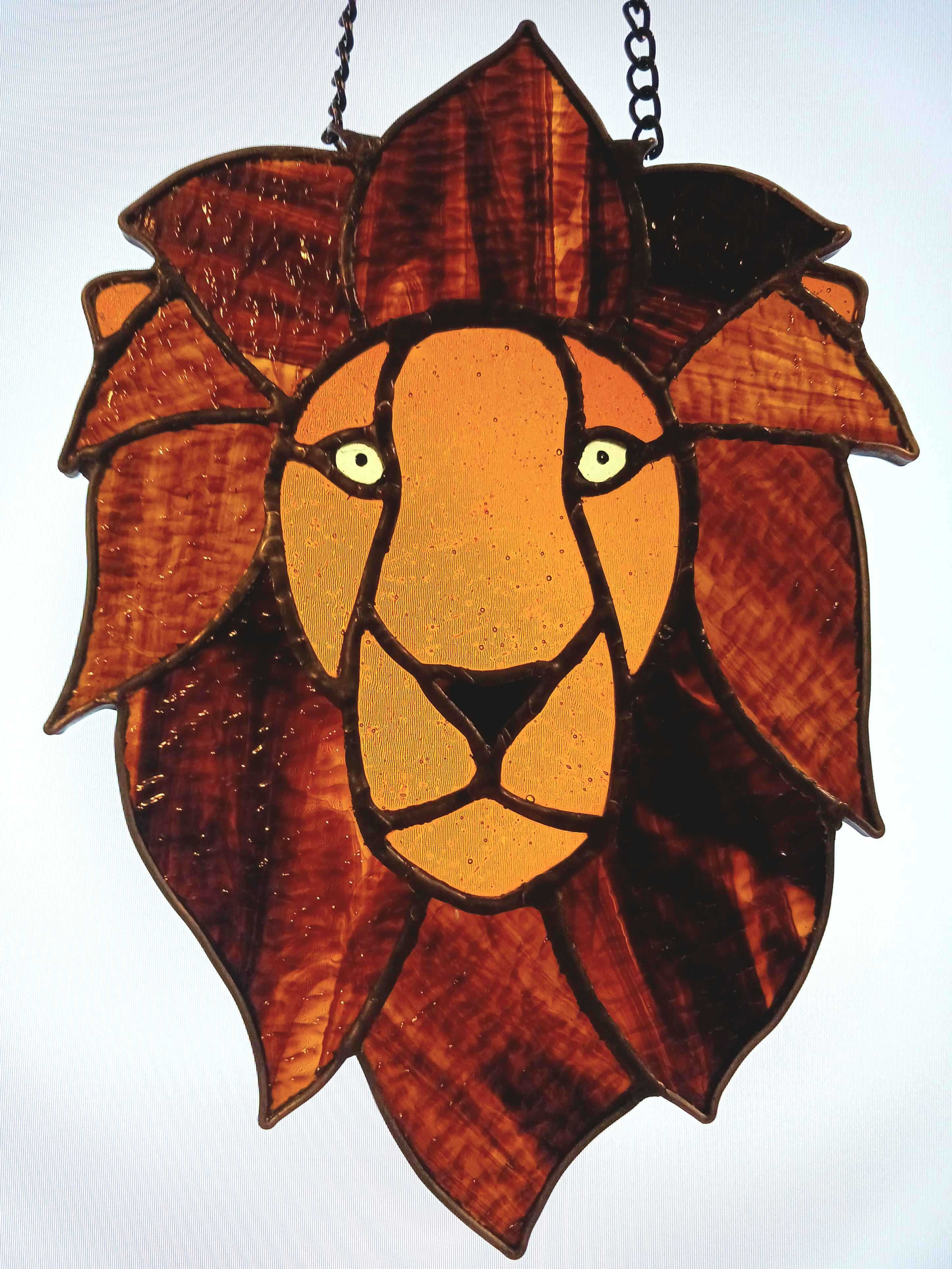 A male lion stained glass piece